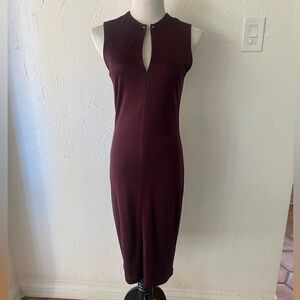 Form-fitting, burgundy dress with keyhole detail.